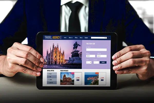businessman showing a travel agency website on a tab